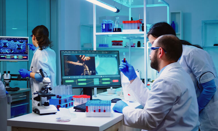 Clinical data managers analyzing trial data in a modern lab using digital tools for advanced clinical data management