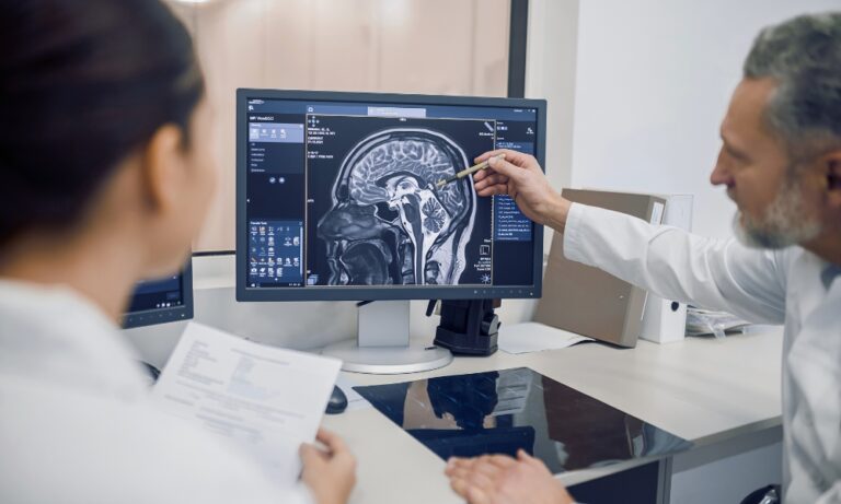 Clinical researcher analyzing brain MRI for medical imaging clinical trials assessment