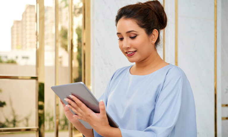 Woman reviewing data on tablet in decentralized clinical trials workflow