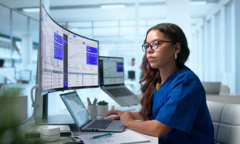 Clinical data reviewer performing source data verification using digital clinical trial dashboards and study records.